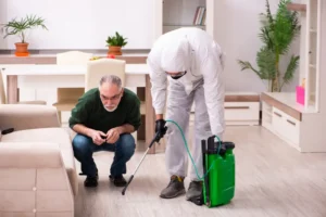 Professional applying treatment on floor as part of pest control before moving.